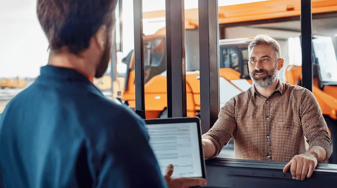 An AI-generated photo of a man at a rental counter and an item that we're not really sure what it's supposed to be in the background. He's renting with a fake ID, though, like many equipment thieves do, exploiting insecure rental processes.